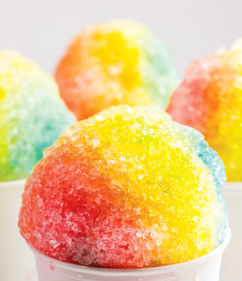Multiple servings of shaved ice. The maker has been careful to apply flavors in a way that creates an ombre.